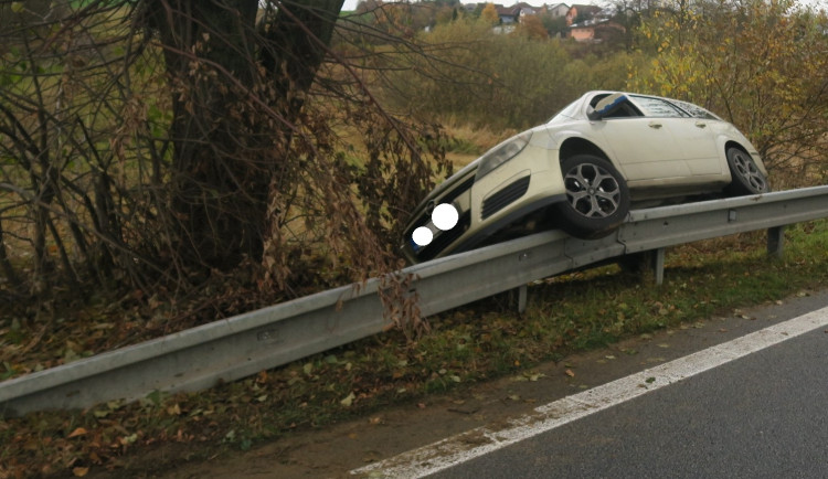 Řidič Opelu jel rychle, dostal smyk a uvízl na svodidlech. K nehodě vyjeli i hasiči, kteří auto vyprostili