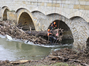 Očista po povodňové hrozbě: Pod historický most v Litovli se spustili hasiči, odklízeli naplavené kmeny