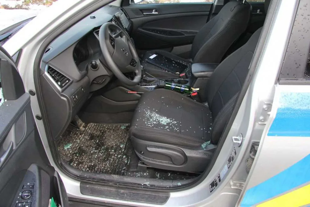 FOTO: Mladík bezdůvodně zaútočil na policistu, který seděl v autě. Na služebně pak prokopl dveře