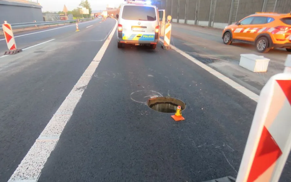 Řidič auta s přívěsným vozíkem na dálnici najel na uvolněný kanál. Náraz vozík vymrštil do vzduchu